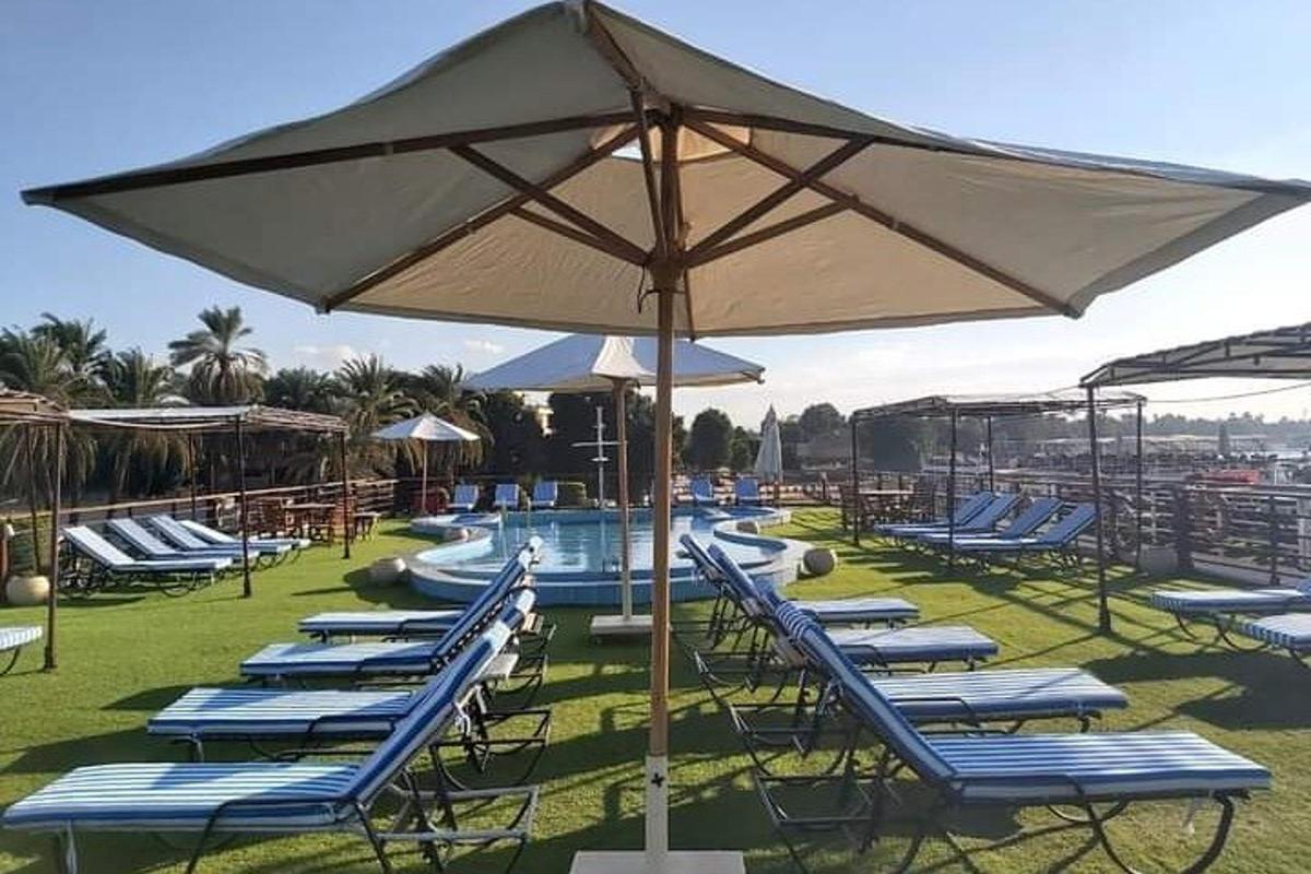 a group of lounge chairs with an umbrella