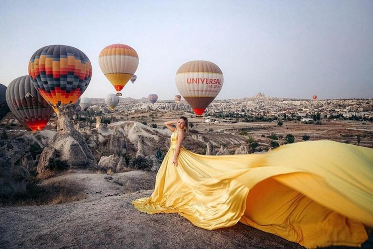seorang wanita berpakaian kuning melihat belon udara panas