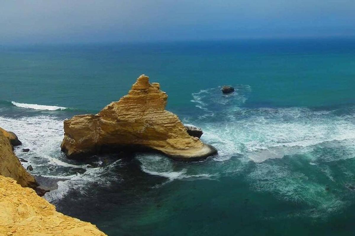 a rock formation in the ocean near the shore