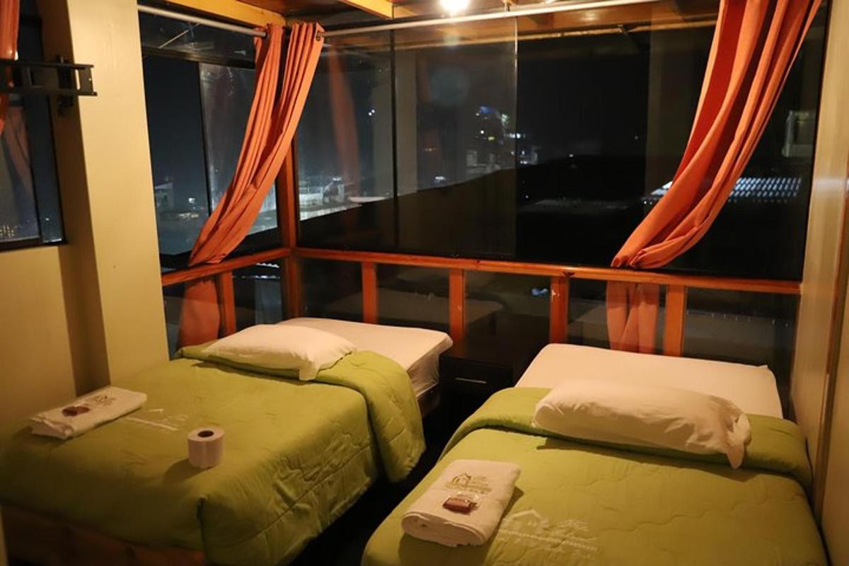 Dos camas en una habitación con ventana.