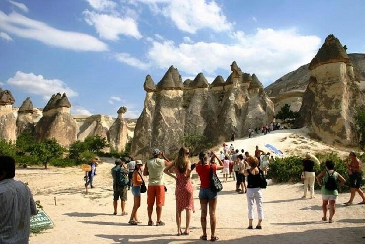 a group of people standing in front of rock formations