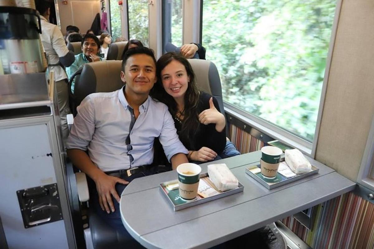 a man and a woman sitting at a table on a train