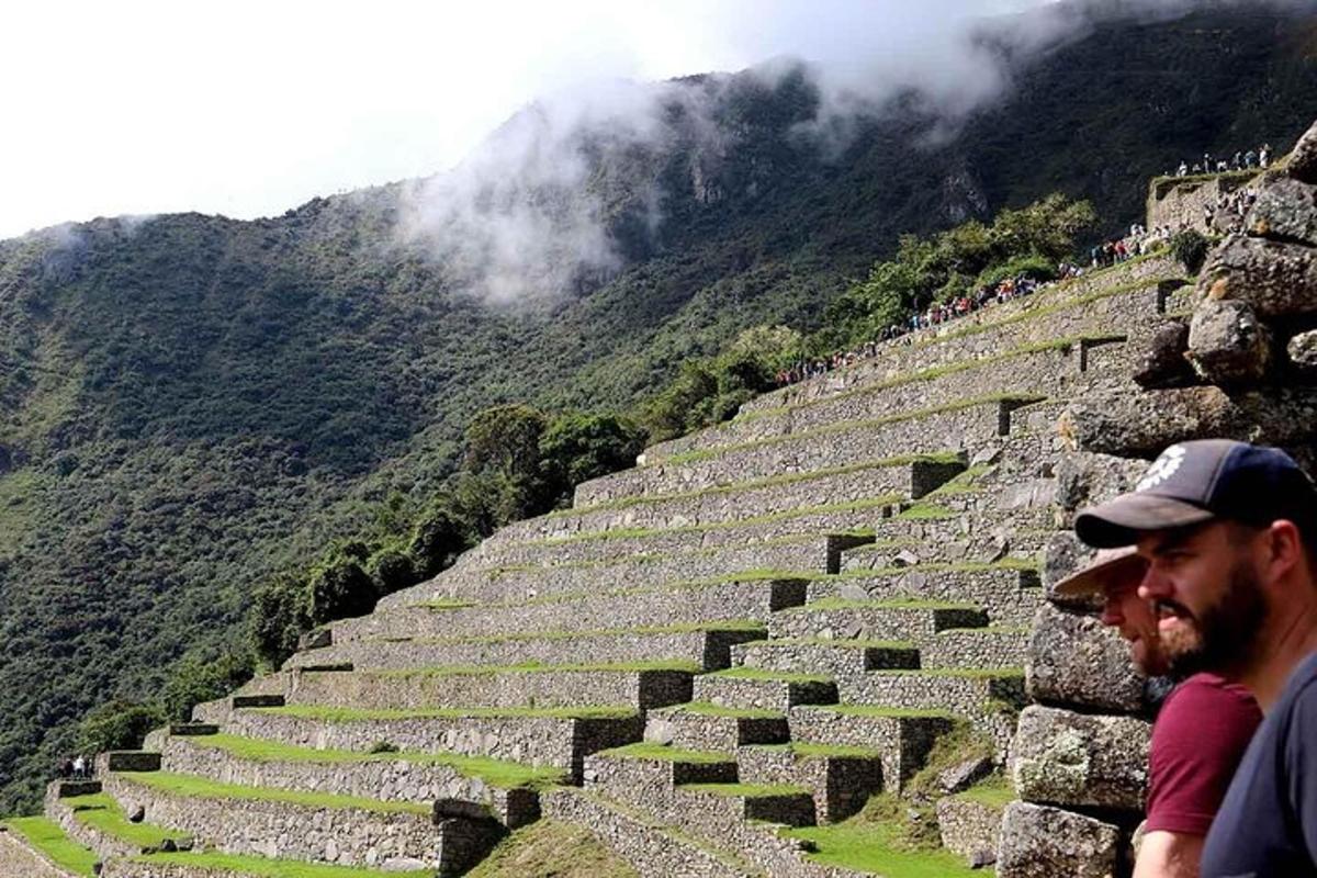two men standing on the ruins of an amphitheater