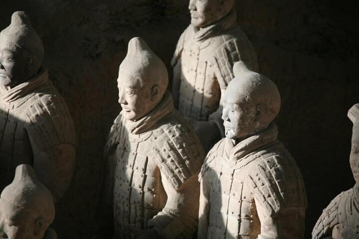 a group of white statues of people on display