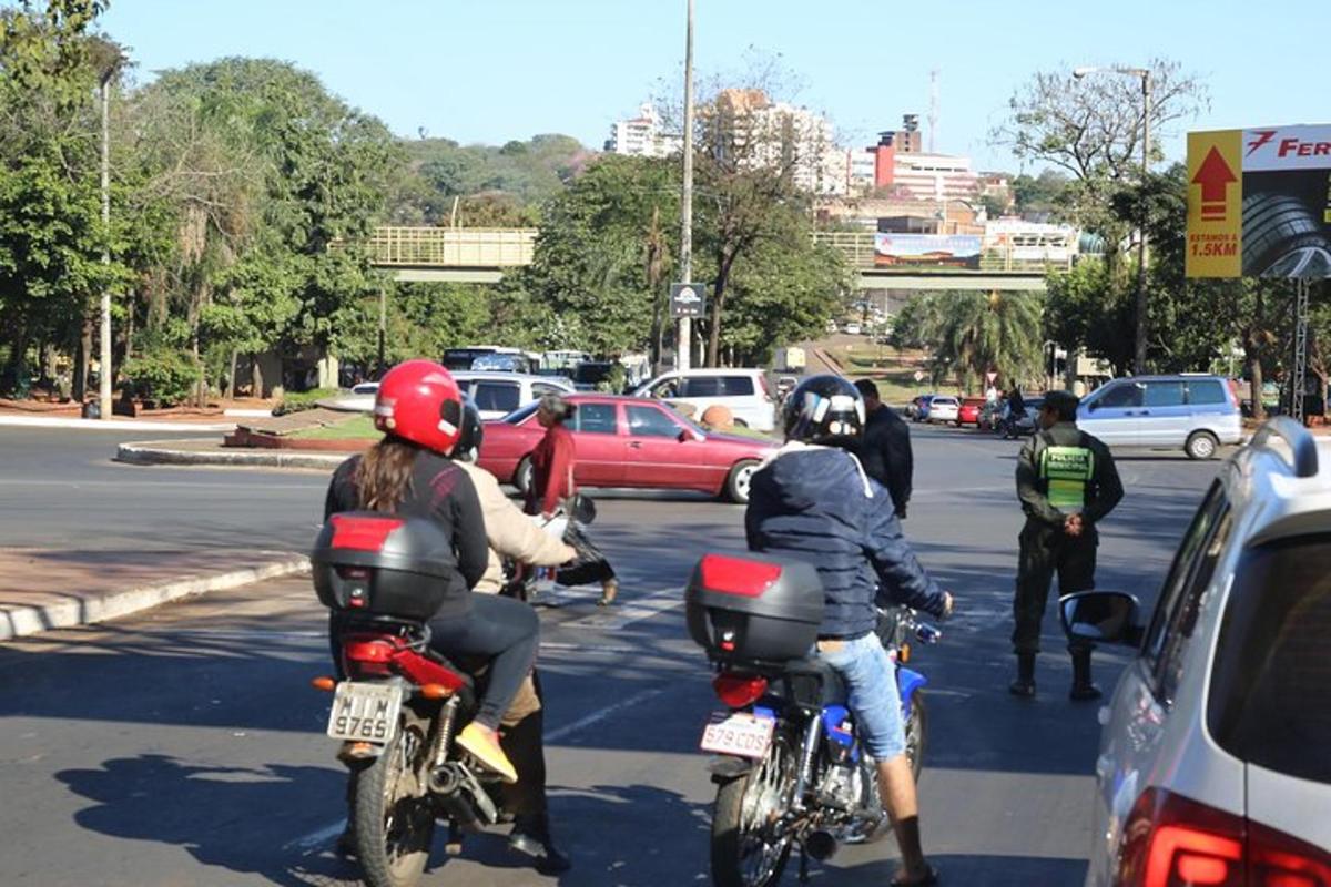 a group of people riding motorcycles down a street