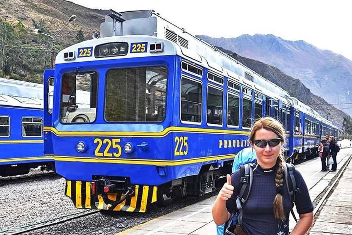 žena stojící před modrým vlakem