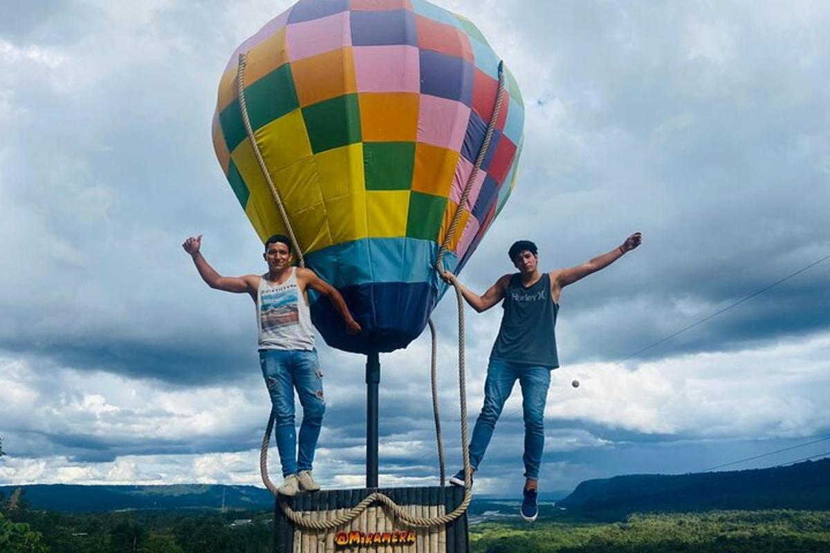 two people standing on top of a hot air balloon