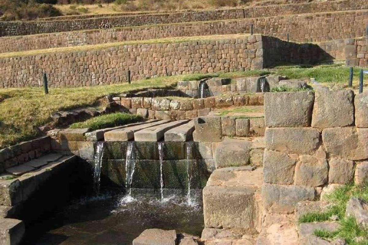 Un muro de piedra con una fuente de agua en el medio.