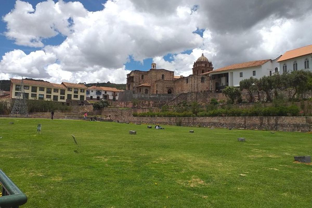 a large green field with a castle in the background