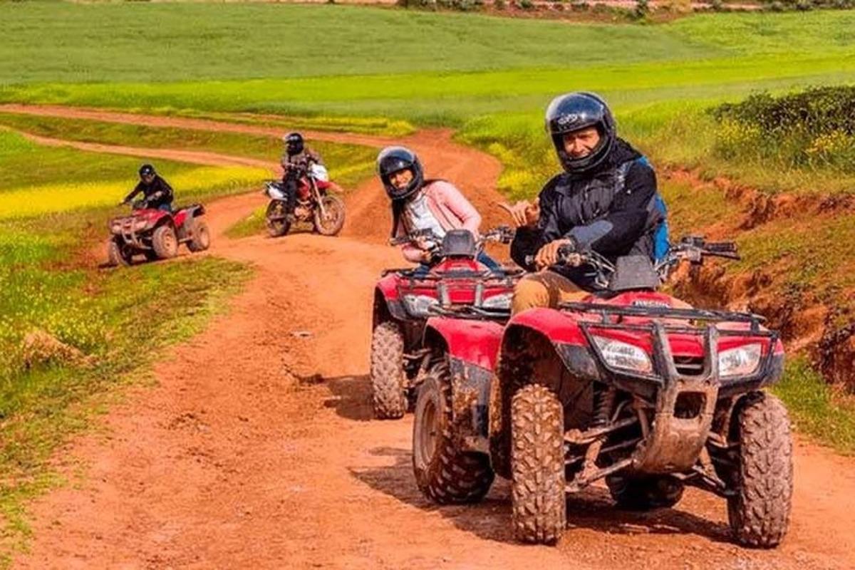 a group of people riding atvs on a dirt road