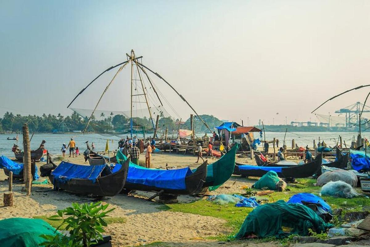 a group of boats on a beach with people