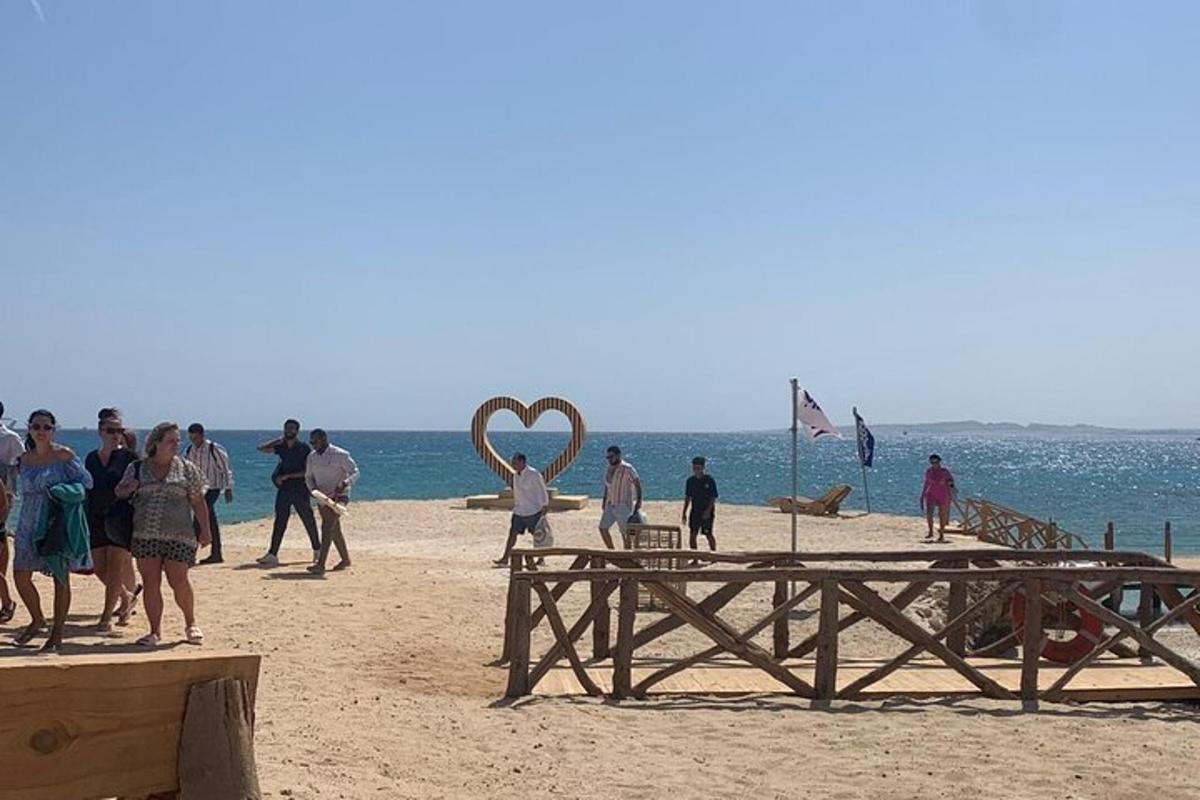 a group of people standing on a beach