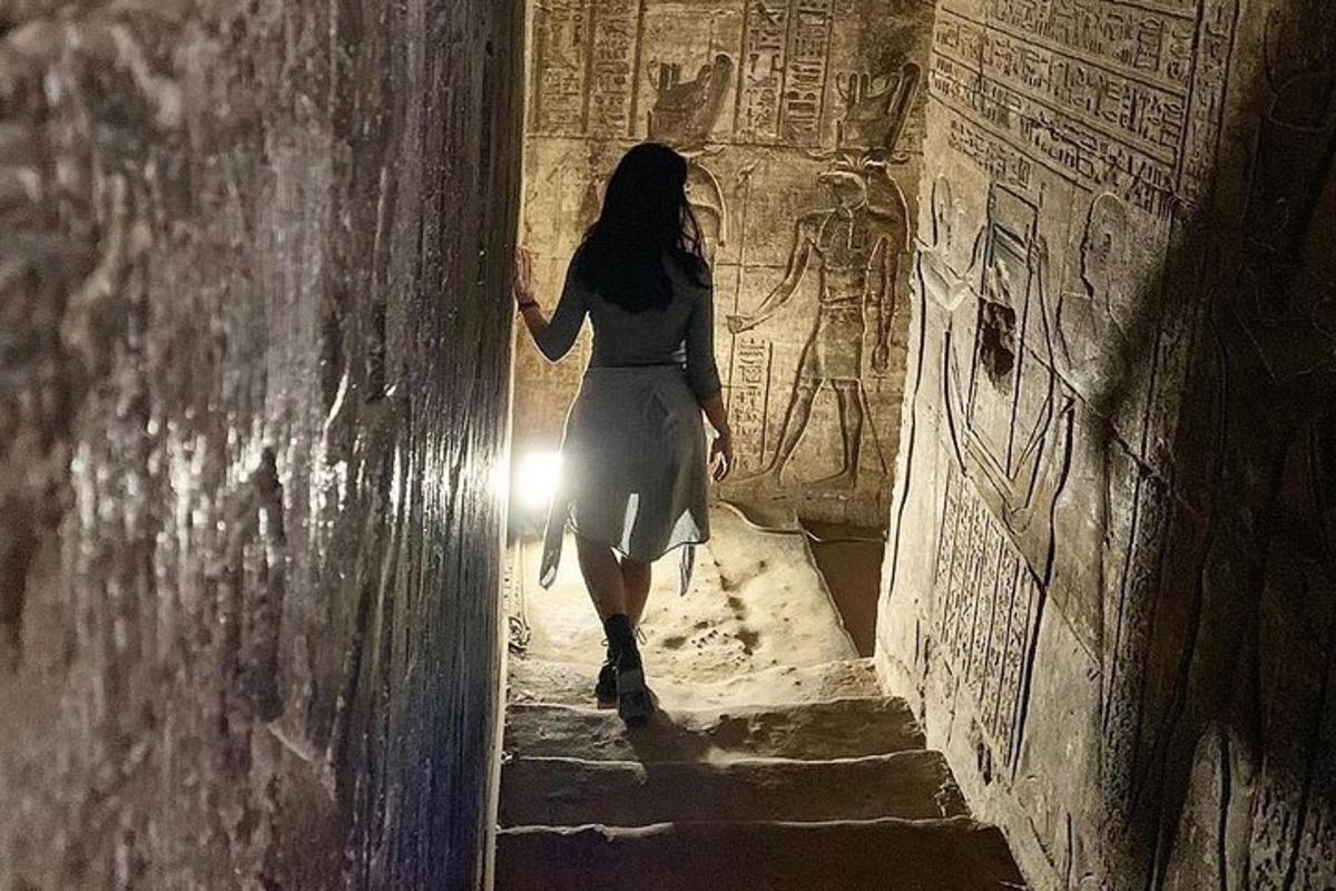 a woman walking down a stairway in an ancient building
