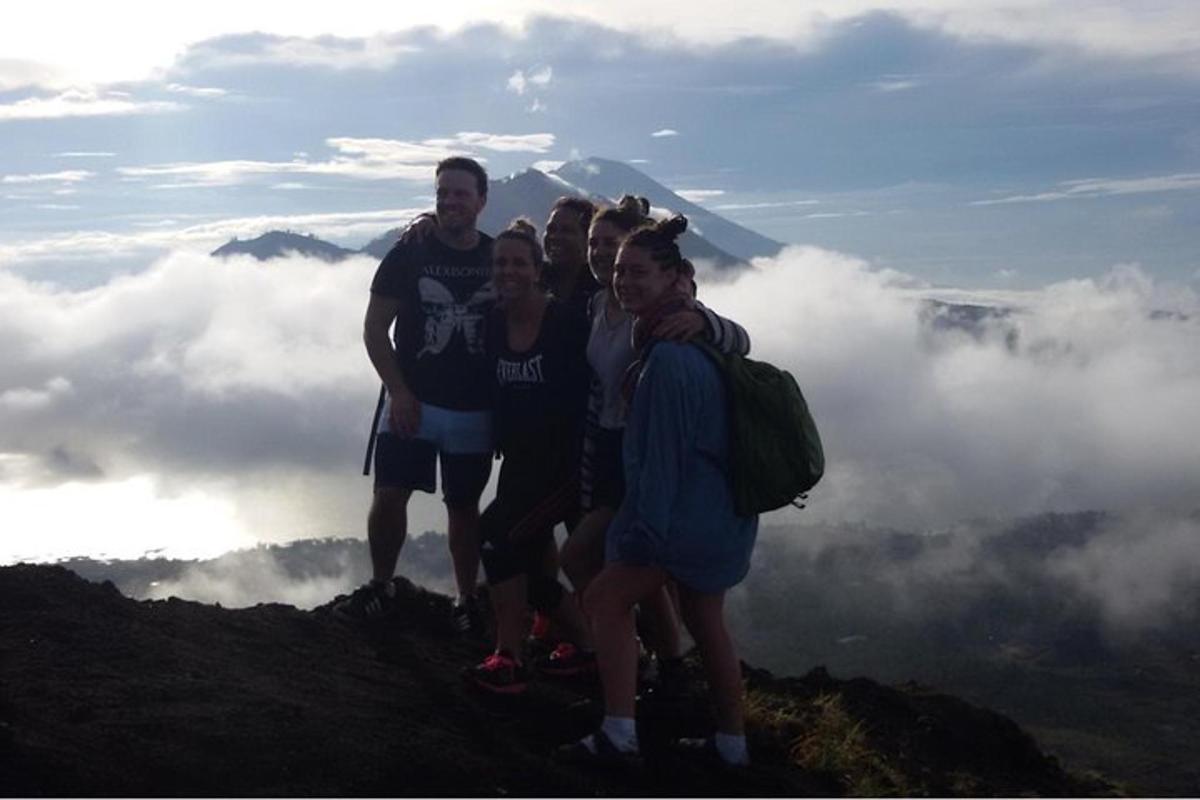 a group of people standing on top of a mountain