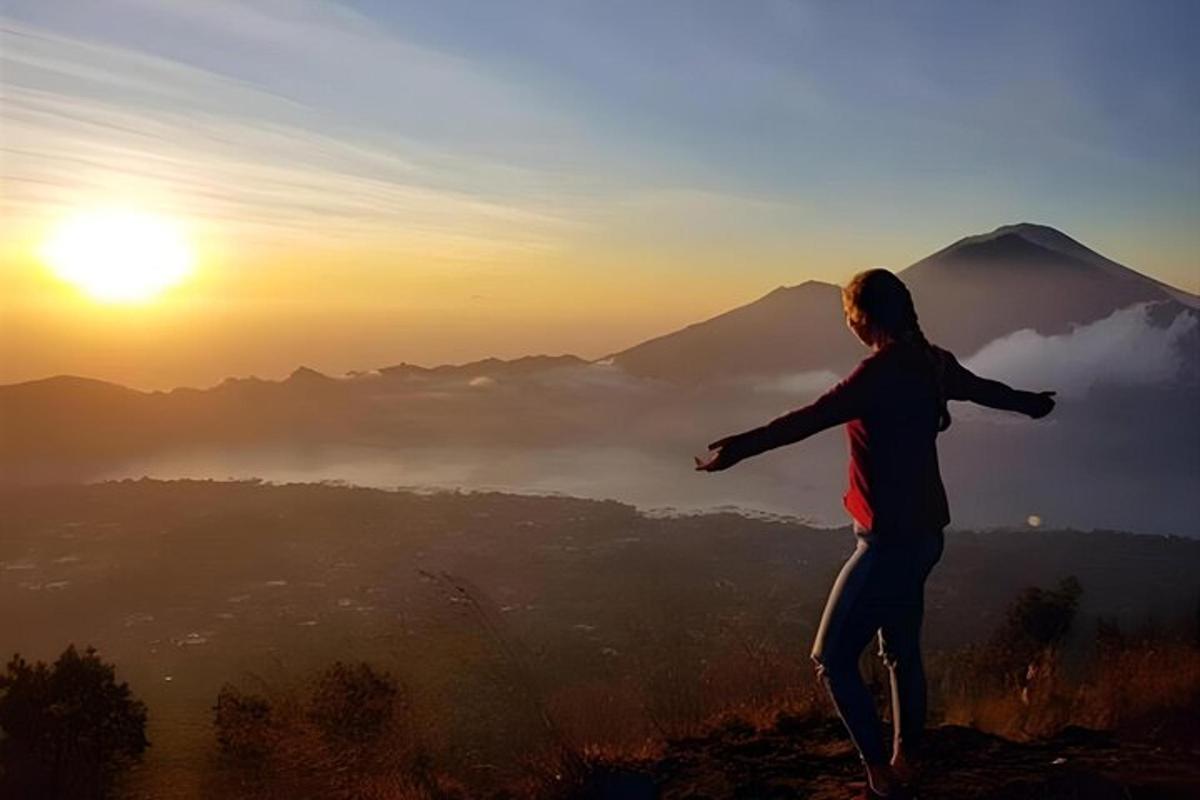 日落时分站在山顶上的女人