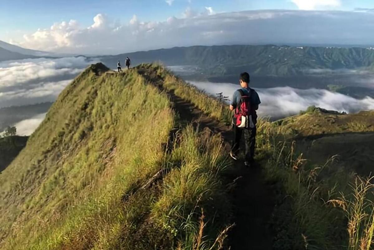 a man standing on the edge of a hill