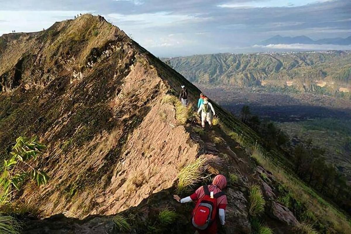a person standing on the side of a mountain