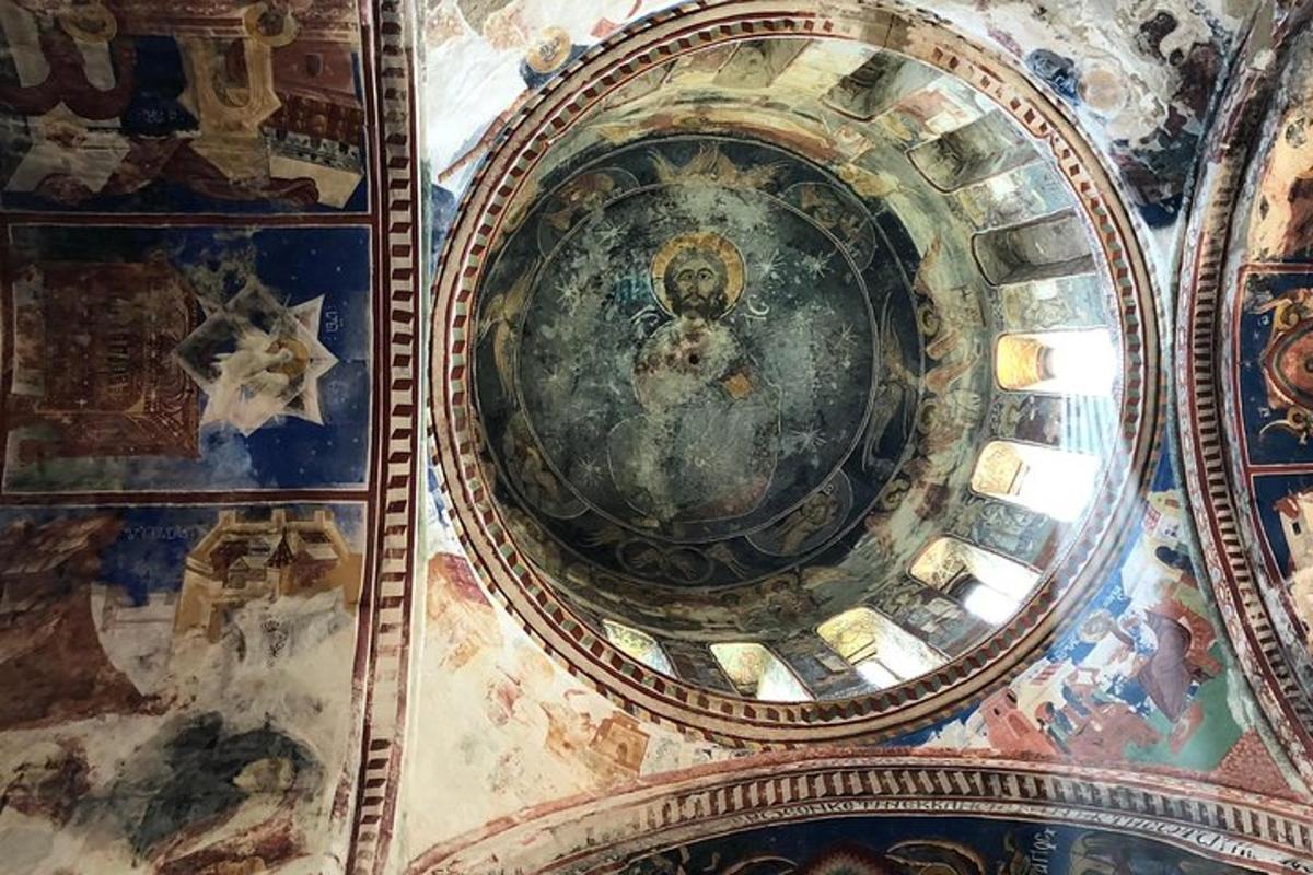 a dome of a church with paintings on the ceiling