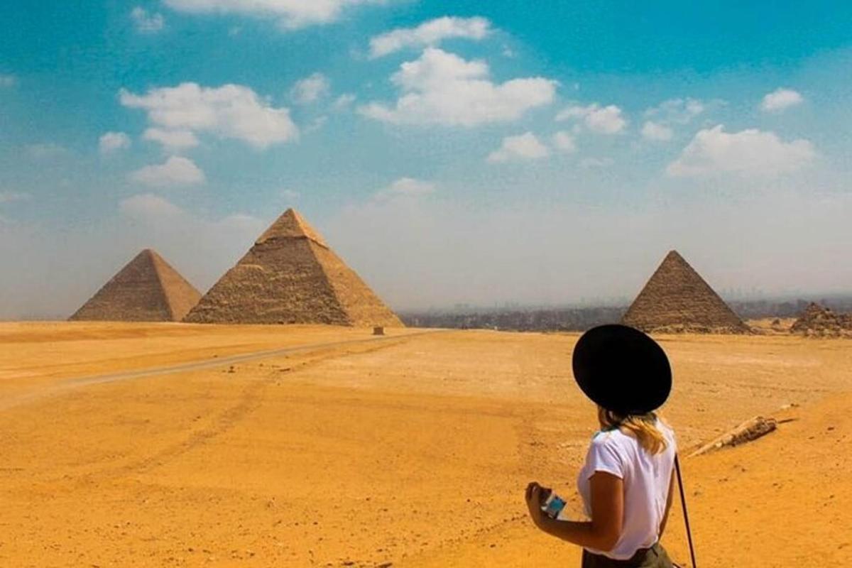 mladá dívka pouští draka před pyramidami