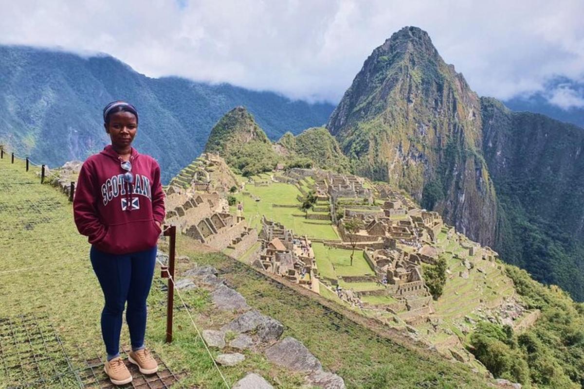 una mujer parada en el borde de una montaña