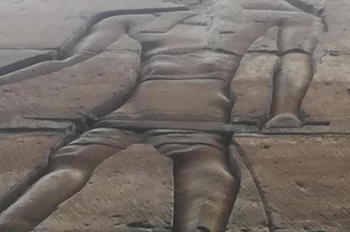 a stone relief of a deity on a wall