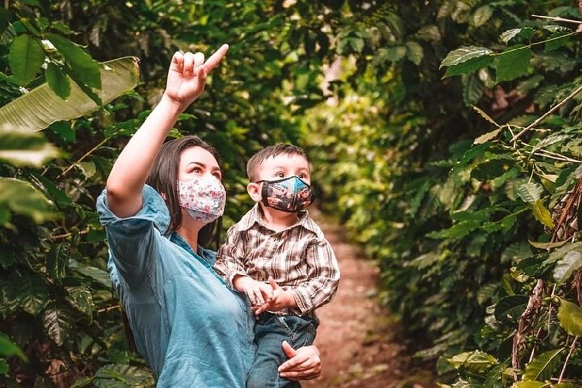 a woman holding a child wearing a face mask