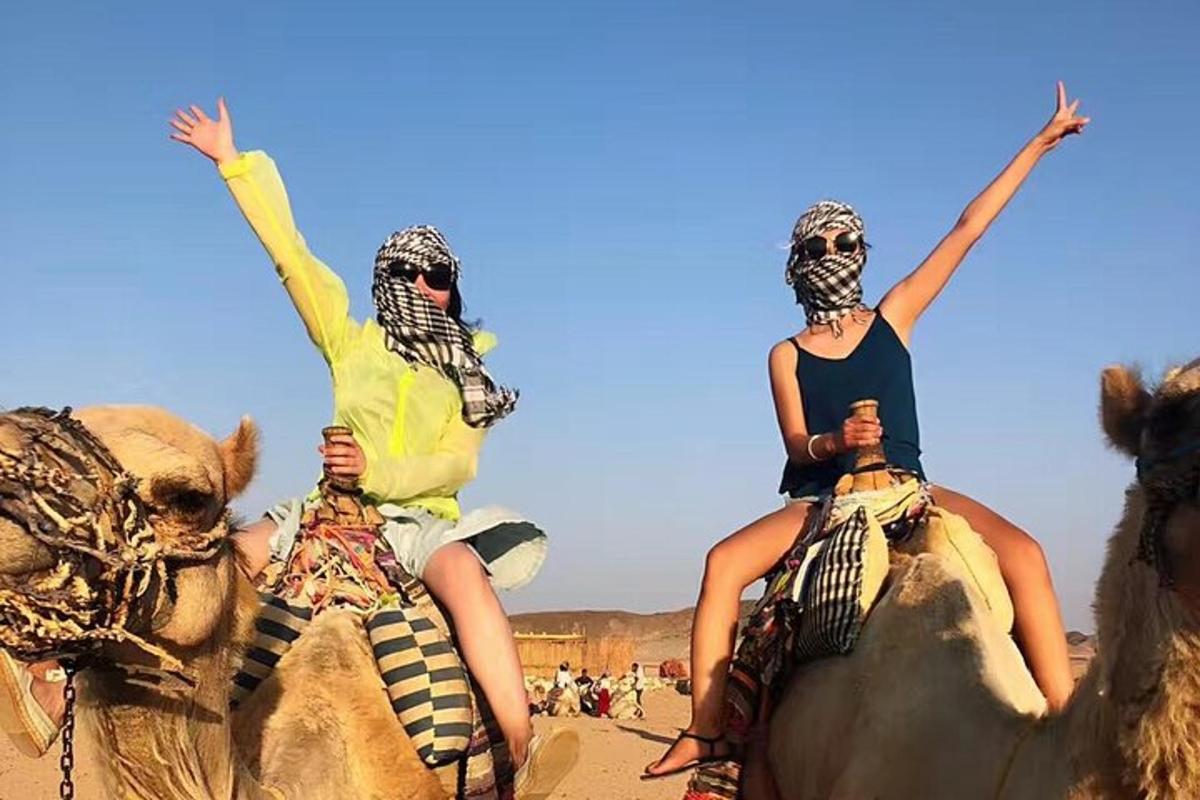 two people riding on the backs of elephants