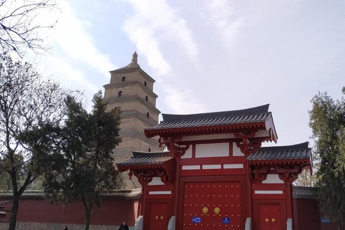 a red building with a tower in the background