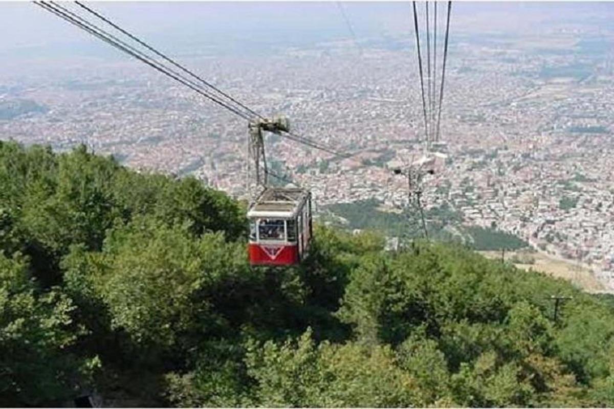 a cable car is flying over a city