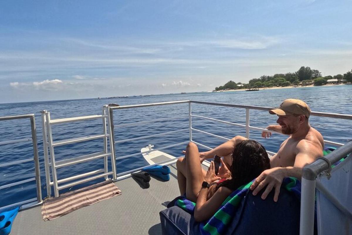 a man and a woman sitting on a boat on the water