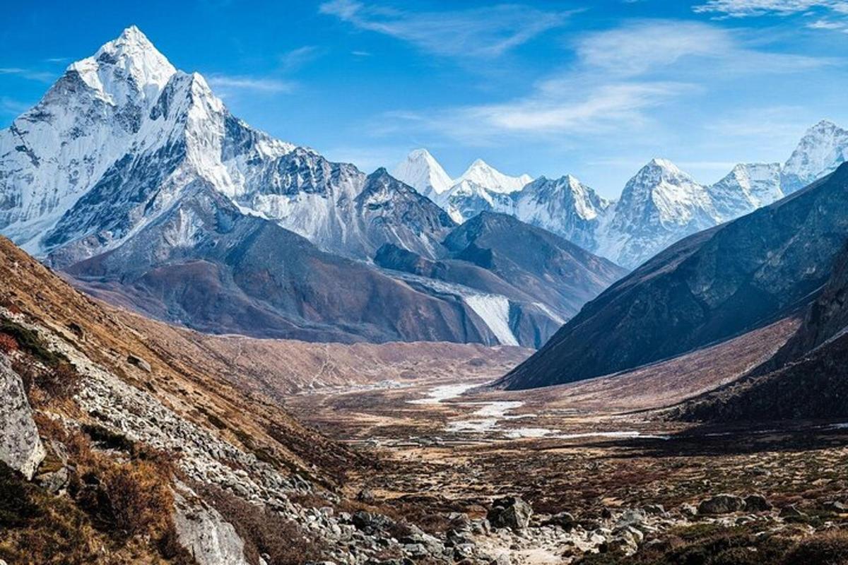 a view of a mountain range with snow capped mountains