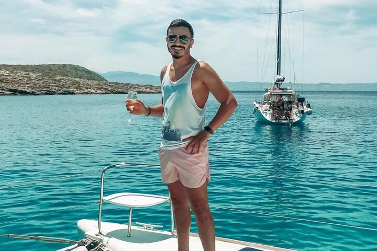 muž stojaci na zadnej strane lode vo vode