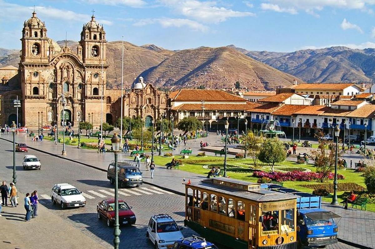 a city with a trolley in front of a church