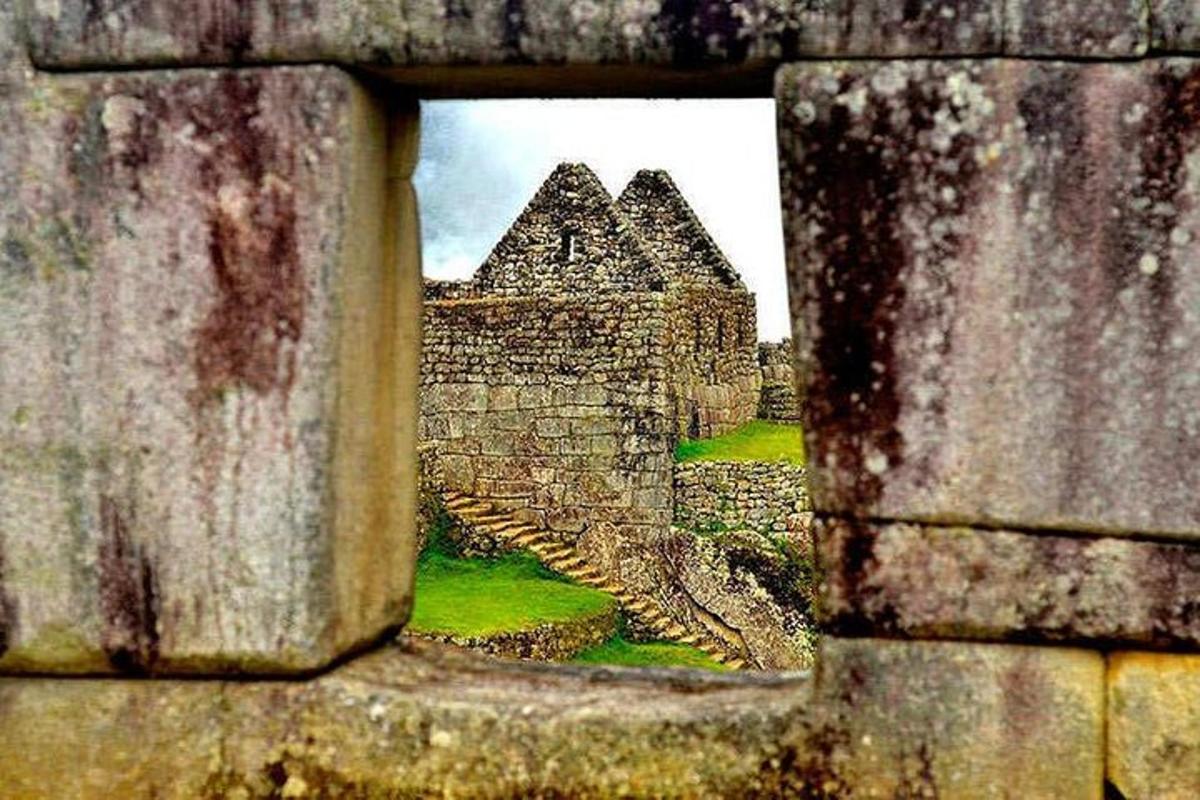 a view of a castle through a stone wall