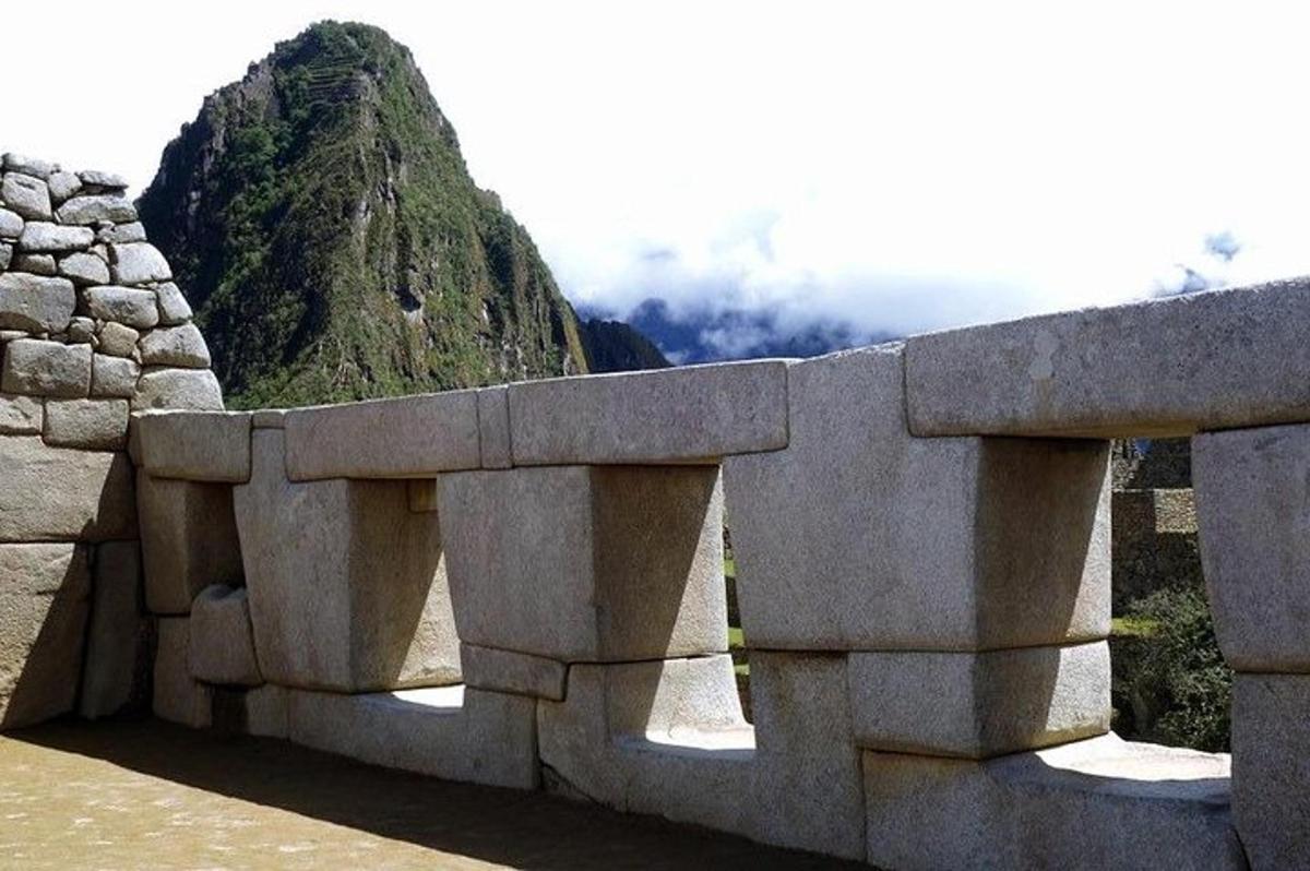 Un muro de piedra con una montaña al fondo