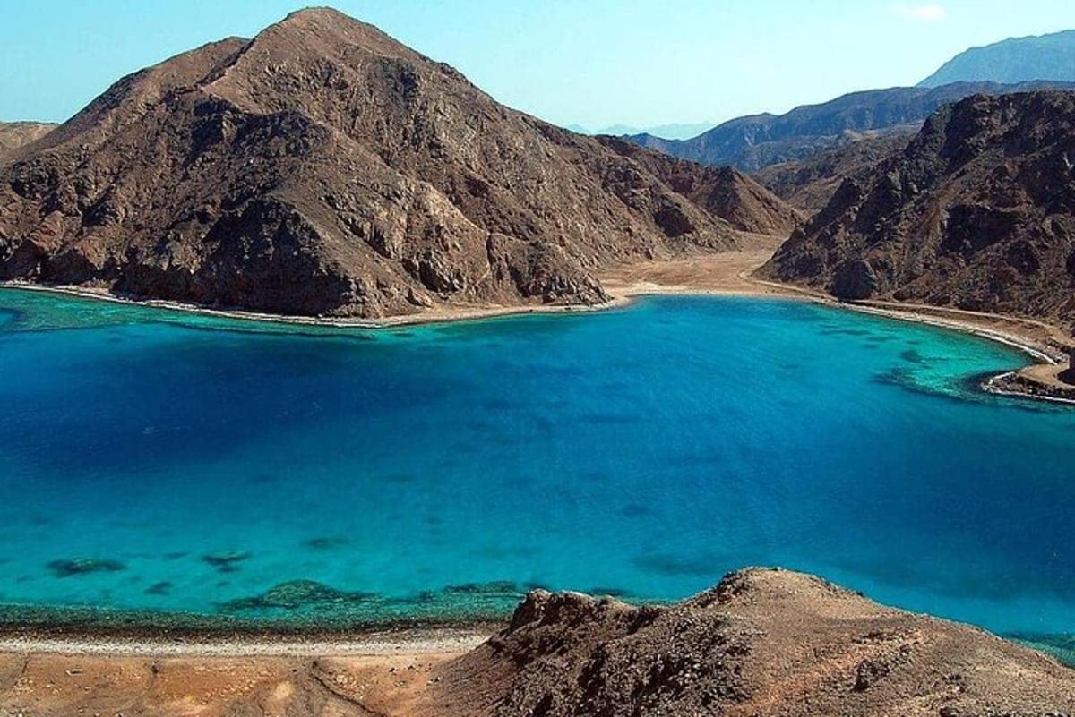 Un gran lago azul en medio de una montaña.