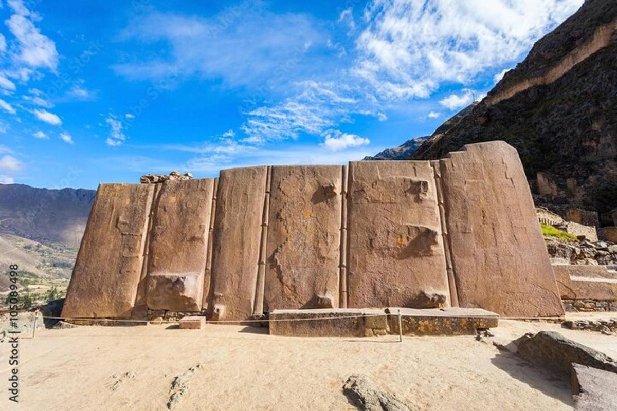 a large stone wall in the middle of a mountain