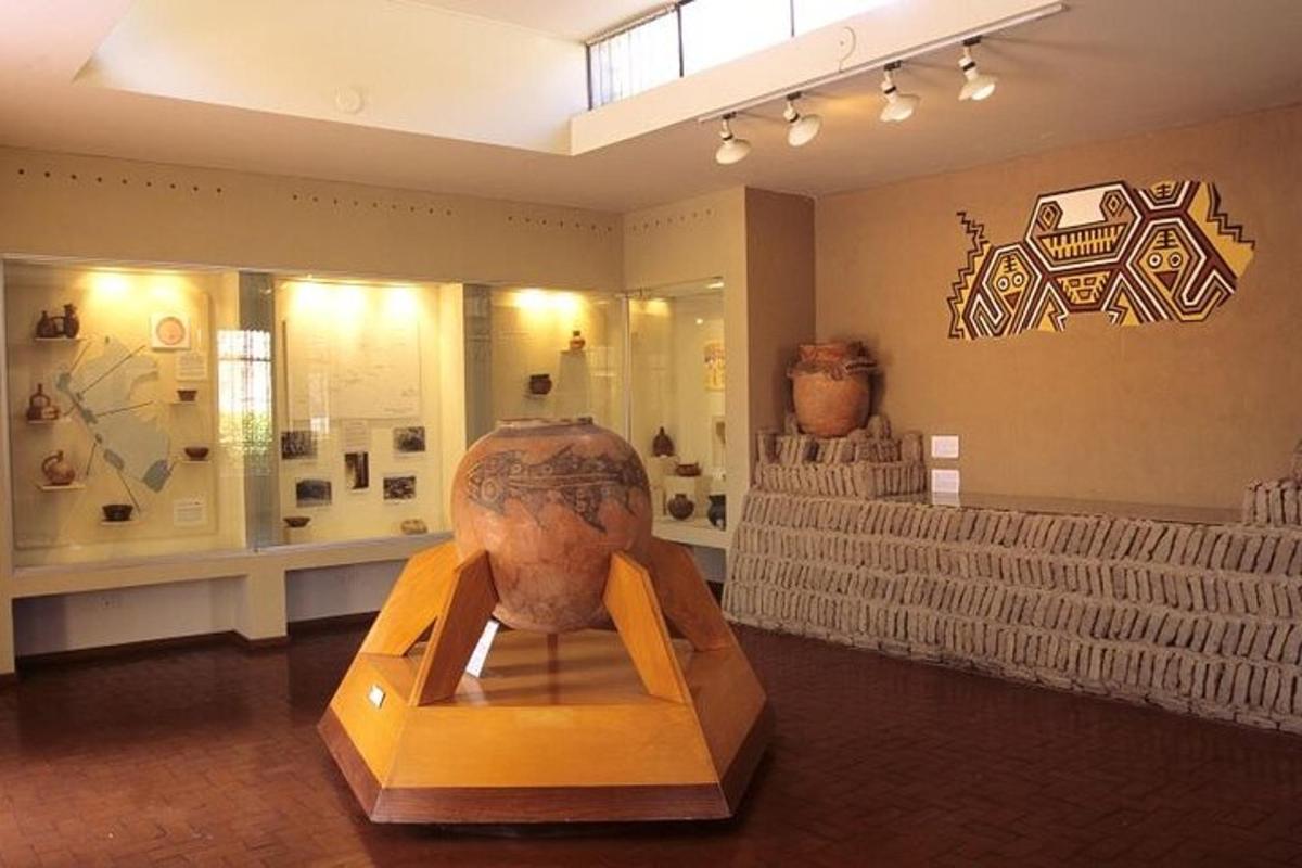 a museum with a vase on display in a room