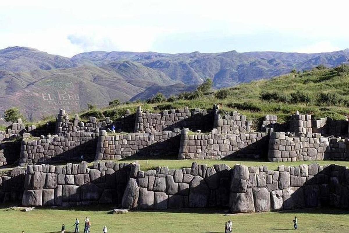 a group of people standing in front of a large stone building