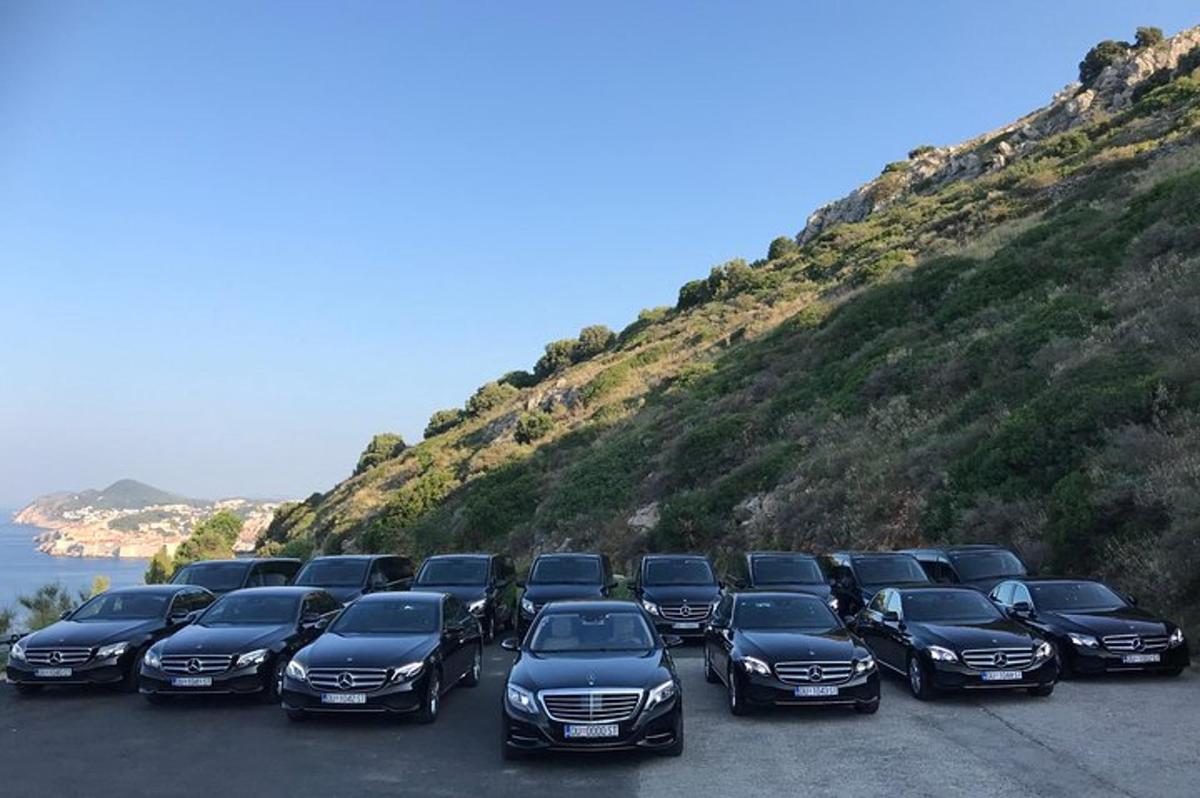 a line of cars parked in a parking lot