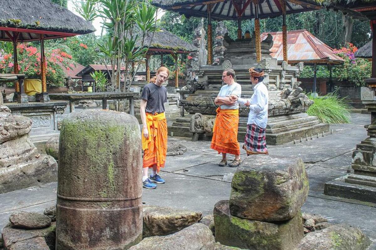 a group of three people standing in a temple