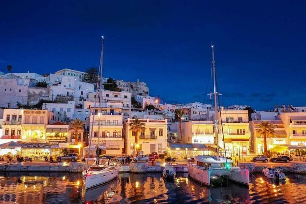 a group of boats docked in a harbor at night