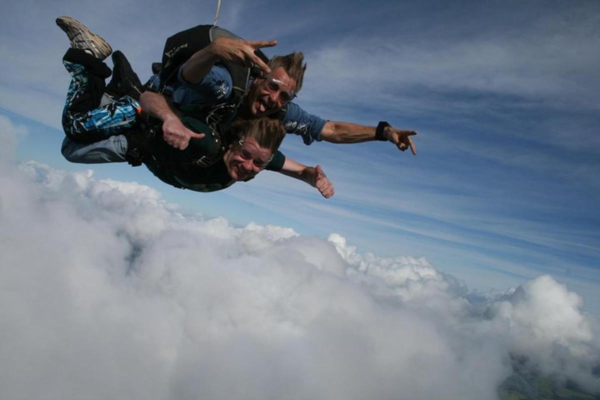 two men are in the air above the clouds