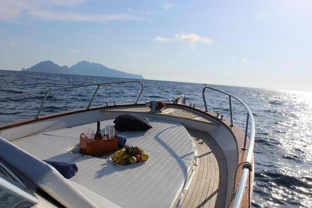 a boat in the water with a bowl of fruit