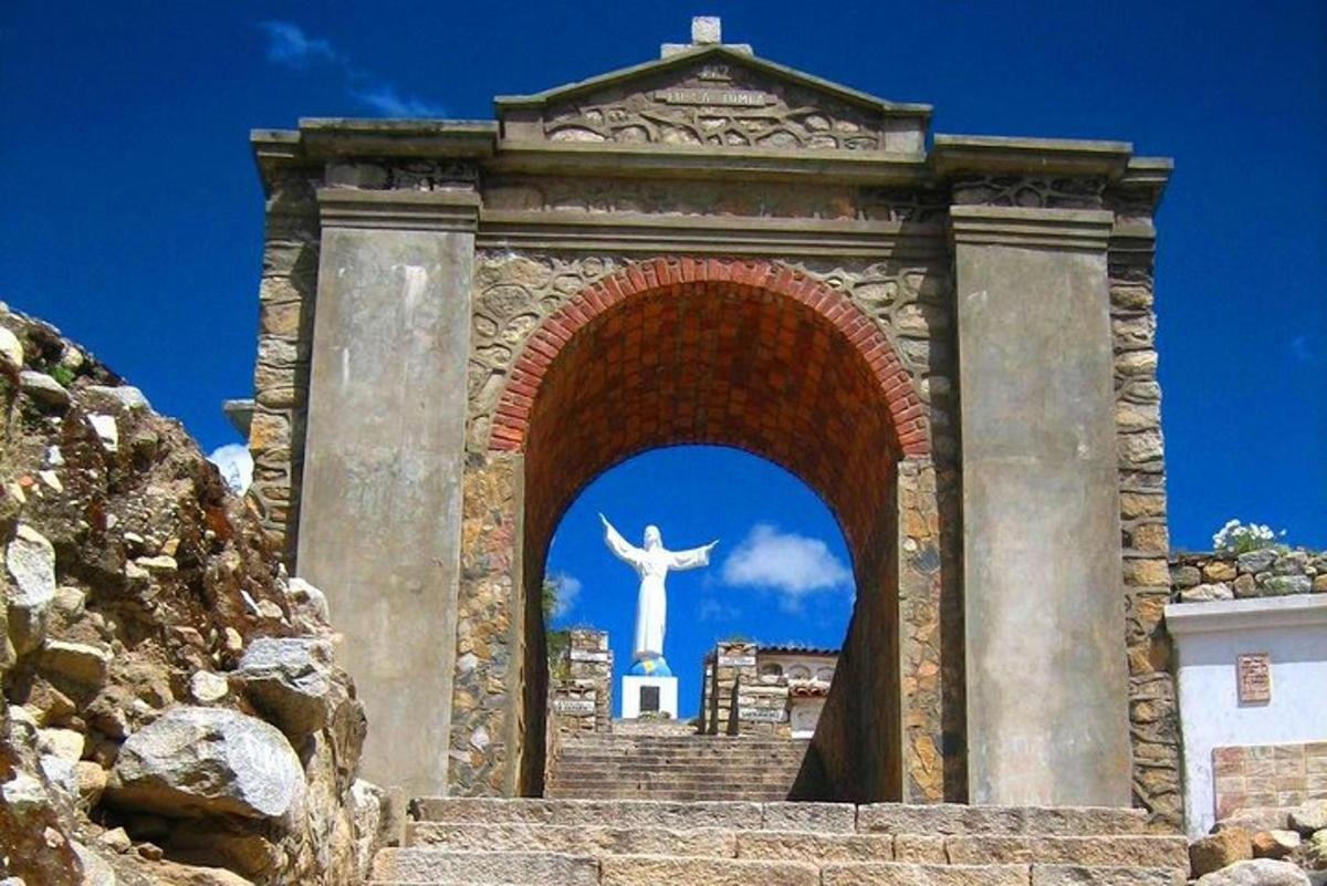 a statue of a christ the redeemer behind an arch