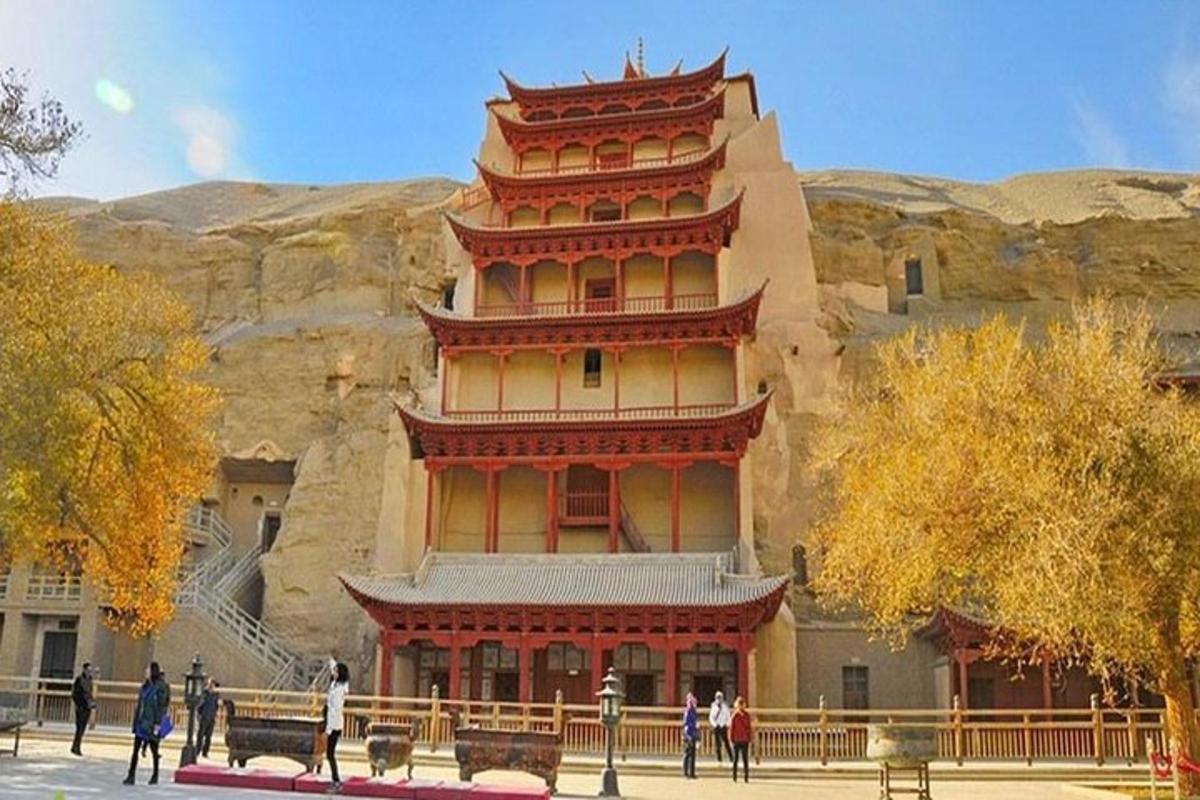 a large building with a tower on the side of a mountain