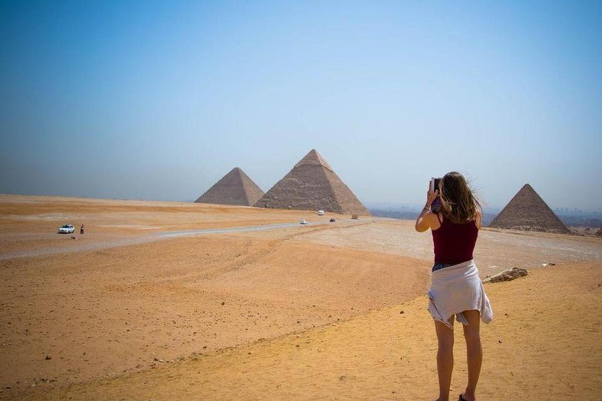 una donna che scatta una foto delle piramidi