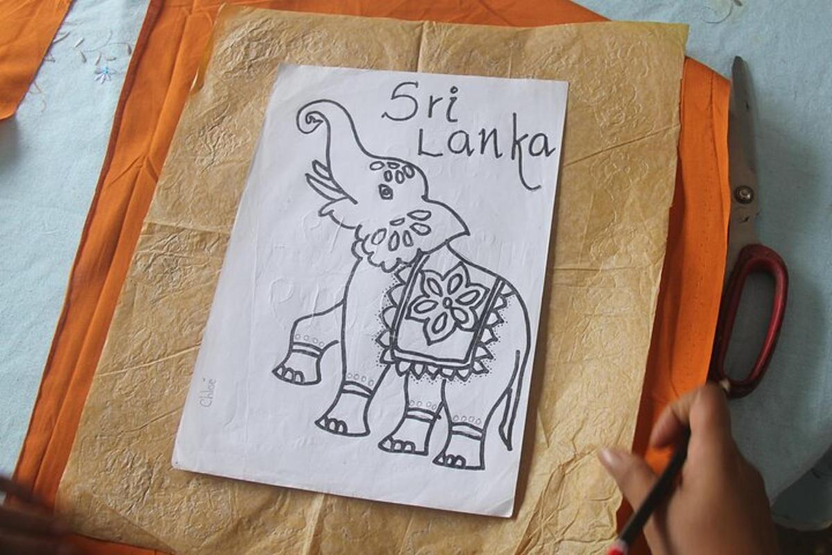 a person holding a piece of paper with a drawing of an elephant