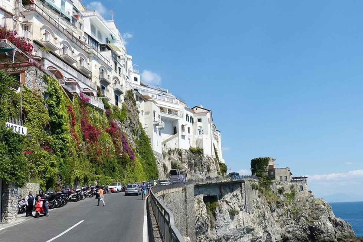 a street with buildings on the side of a mountain