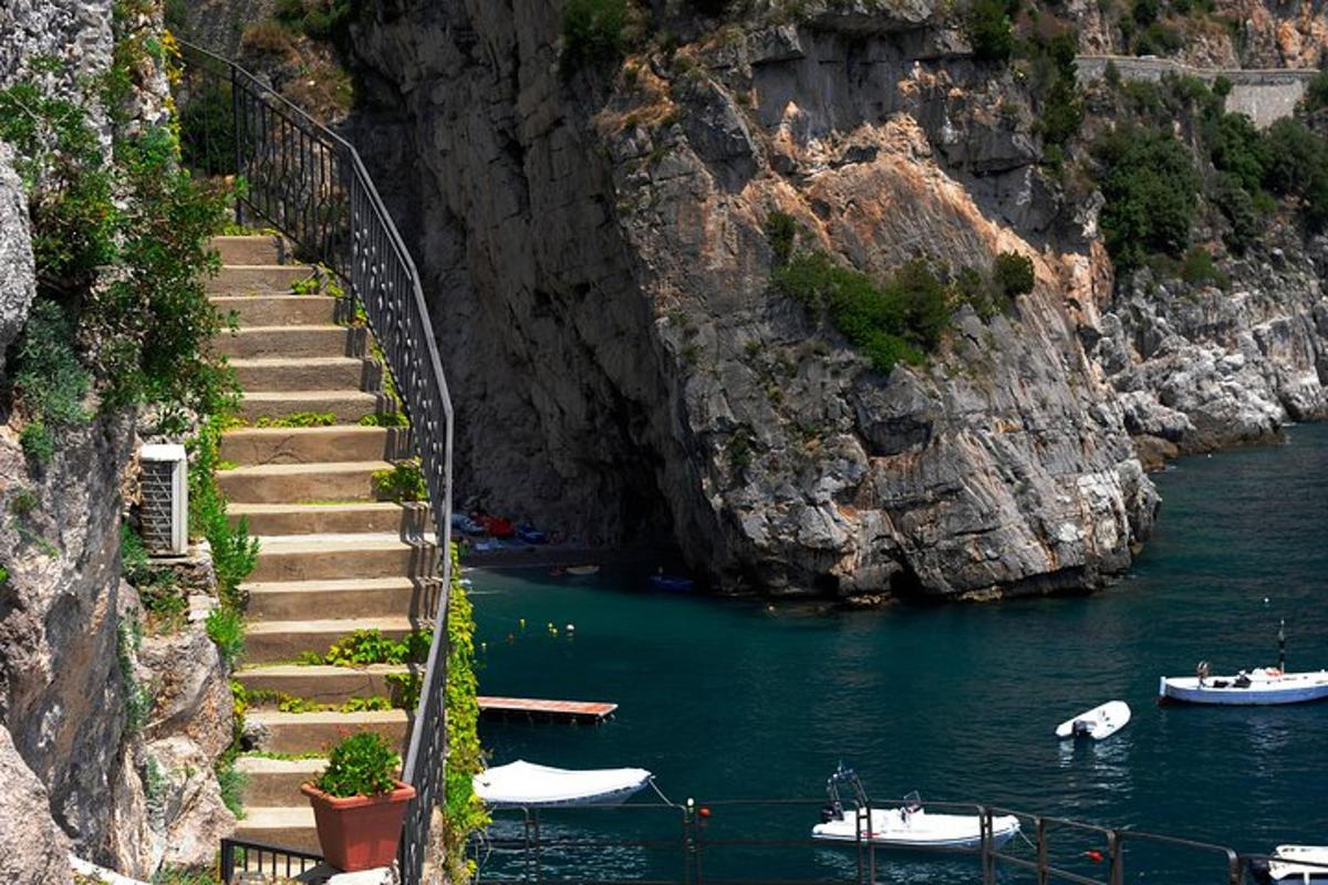 a staircase leading to a body of water with boats